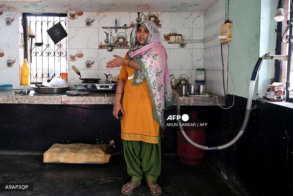 This photograph taken on April 24, 2026 shows villager Gauri Devi, who cooks food using biogas, speaking during an interview with AFP at her residence in Uttar Pradesh's Bulandshahr district.