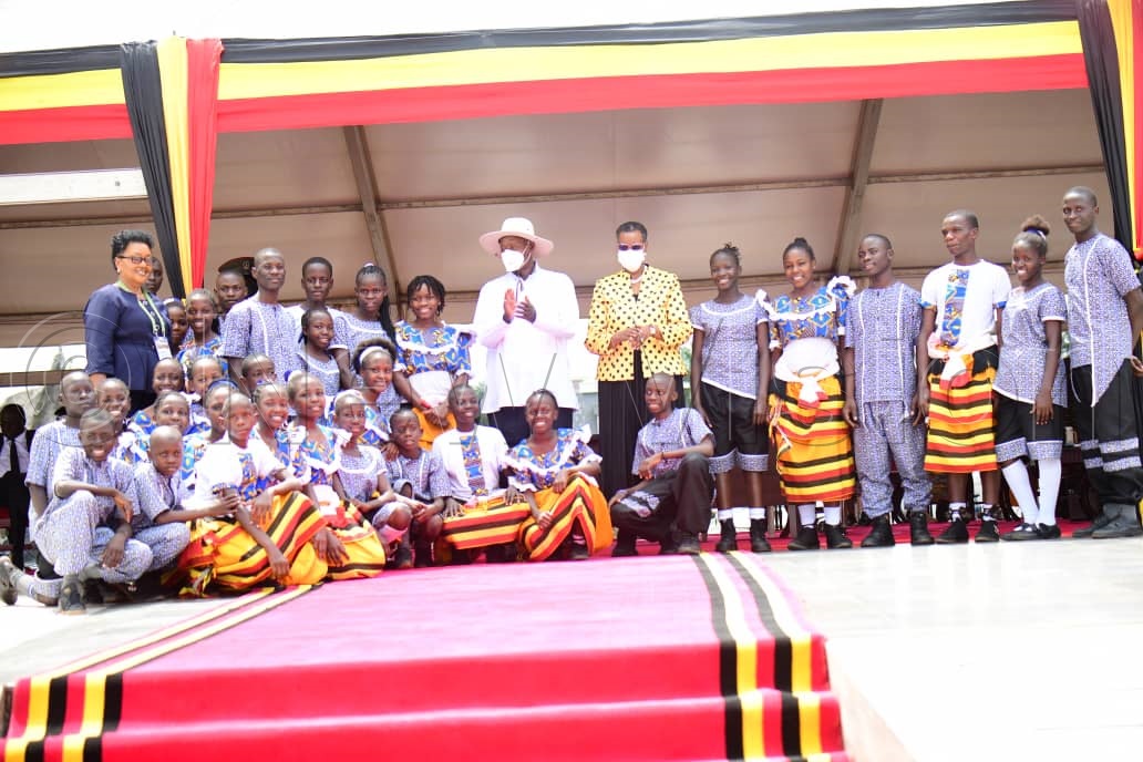 Nakivubo Blue Primary School dance group pose for photo with president Museveni and the First Lady after preforming at the independence day celebrations. (Credit: Maria Wamala)