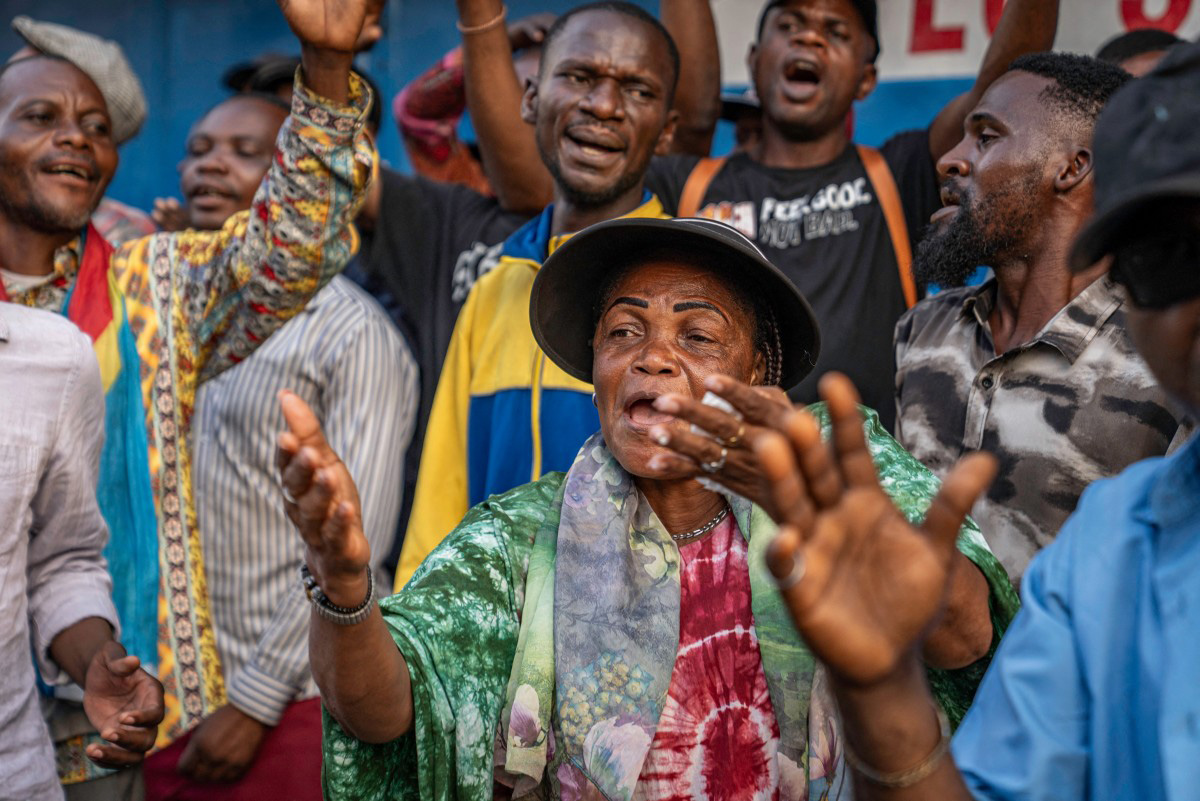 A female activist from the presidential party, the Union for Democracy and Social Progress (UDPS), singing in praise of President Felix Tshisekedi, in Kinshasa on March 27, 2026. (Photo by Glody MURHABAZI / AFP)