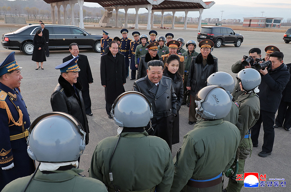 North Korean leader Kim Jong Un (C) encouraging pilots at an event marking the 80th anniversary of the founding of the Korean People's Army Air Force at Kalma Airfield in Wonsan, Gangwon Province. (Photo by KCNA VIA KNS / AFP)