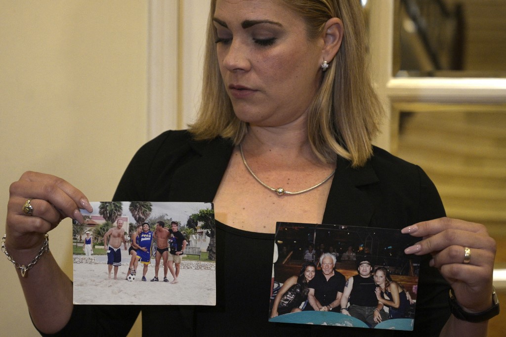 Cuban Mavys Alvarez displays photos with Maradona in a Cuba. AFP Photo