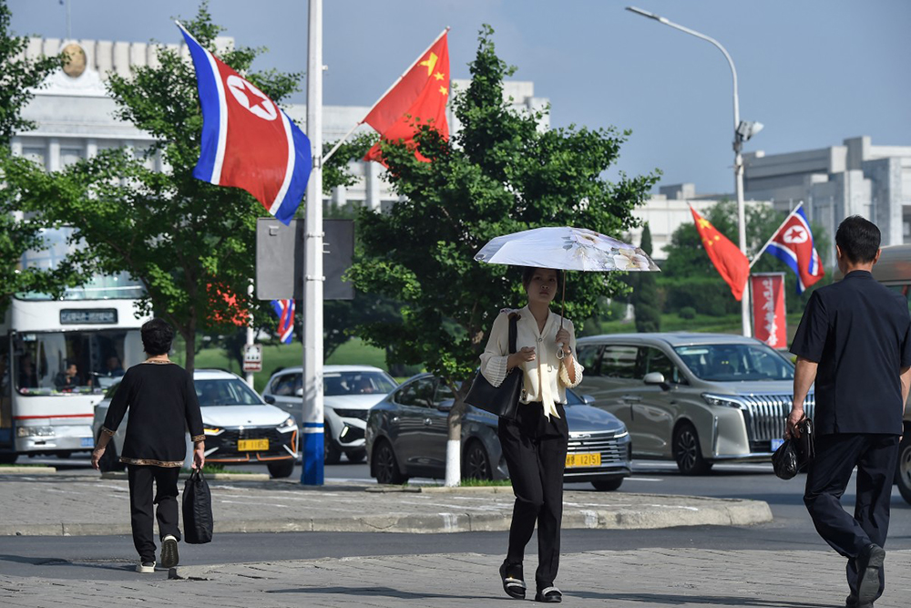 The national flags of North Korea and China are displayed on a street in Pyongyang on June 8, 2026.