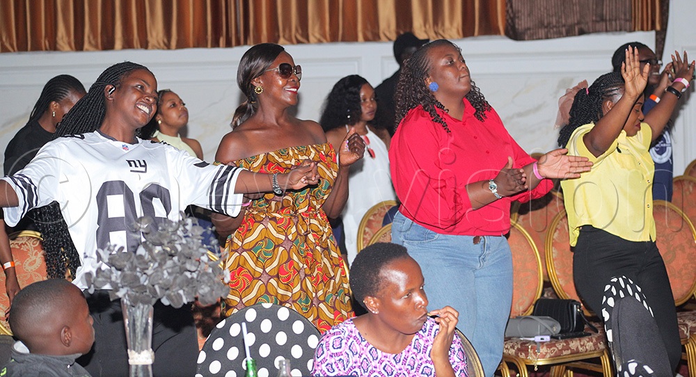 Attendees waving their hands while Godfrey Kwezi sang during his concert at Imperial Royal Kampala. (Photo by John Musoke)