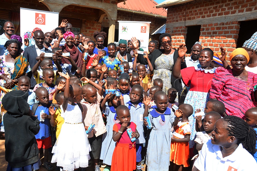 Literacy and Adult Basic Education (LABE) Executive Director Stella Tumwebaze (wearing spectacles) poses for a group photo with learners of Kalama Inclusive Home-Based Learning Centre and their parents in Kyamulimbwa Town Council, Kalungu District. (Photo by Francis Emorut)