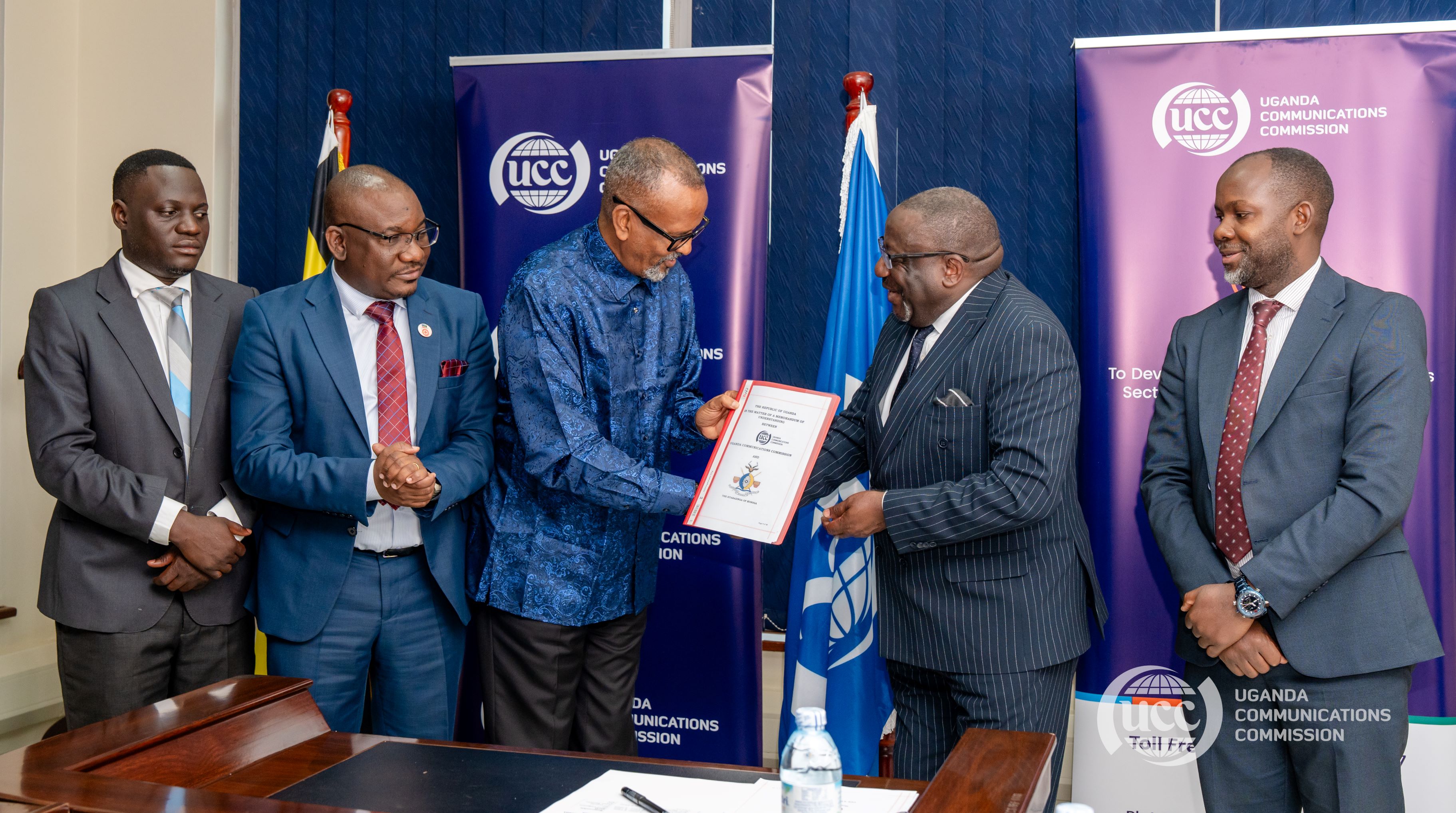 Busoga Kingdom's 2nd deputy Prime Minister Al-Haji Osman Ahmed Noor (C) and UCC's Executive Director Nyombi Thembo (2nd R) holding the MOU document after the signing ceremony at UCC headquarters in Kampala on June 2nd. Looking on is Busoga Kingdom's Constitutional Affairs Minister Alex Luganda (2nd L) and Busoga Kingdom's State Minister for Finance Ivan Kiirya (L) who witnessed. (Courtesy Photo)