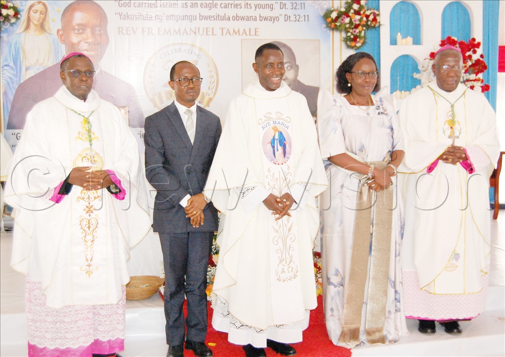 Rev. Fr. Emmanuel Tamale (centre) shares a photo-moment with Bishop Lawrence Mukasa (left), Buganda Kingdom minister of Local Government Joseph Kawuki (second-left), Lands minister  Judith Nabakooba (fourth-left) and Bishop Joseph Antony Zziwa. This was during Tamale's 25th prestly anniversary celebration at his parental home at Kanziira-Kattabalanga, in Mubende Municipality on Friday, September 25, 2026. 