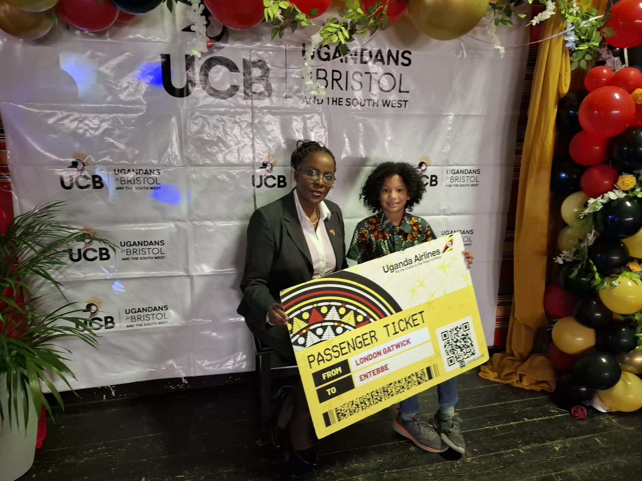 Tobin, an 11-year-old who wants to be a Uganda Airlines pilot in future with the country manager.