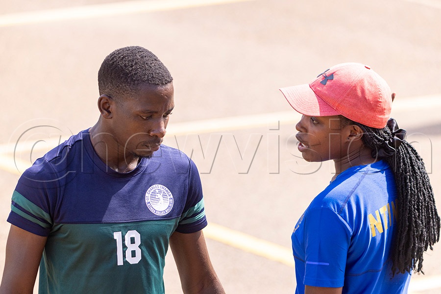 St. Charles Lwanga Ntinda Volleyball Club team with coach Casandra Nabatanzi giving instructions to a player during a league game