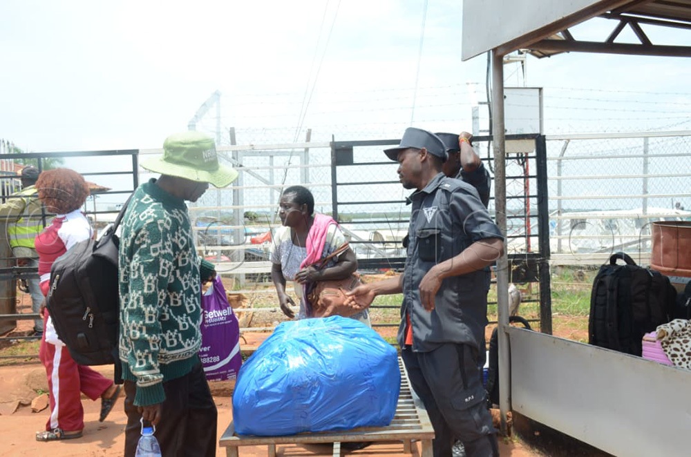 Some of the passengers undergoing security checks before boarding. (Photo by Samuel Nkuba)