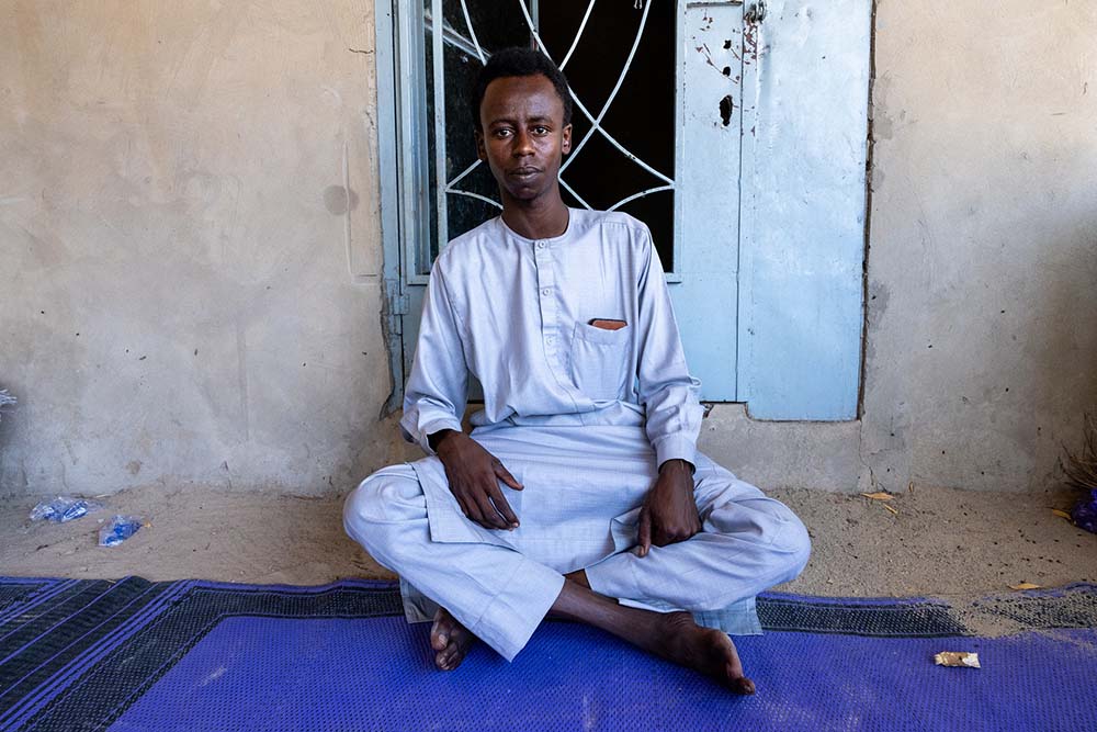 Tahir Lool, 28, who is unemployed, sits while posing for a photograph in Baga Sola, Lake Chad Province, Chad, on June 25, 2025. (Credit: AFP)