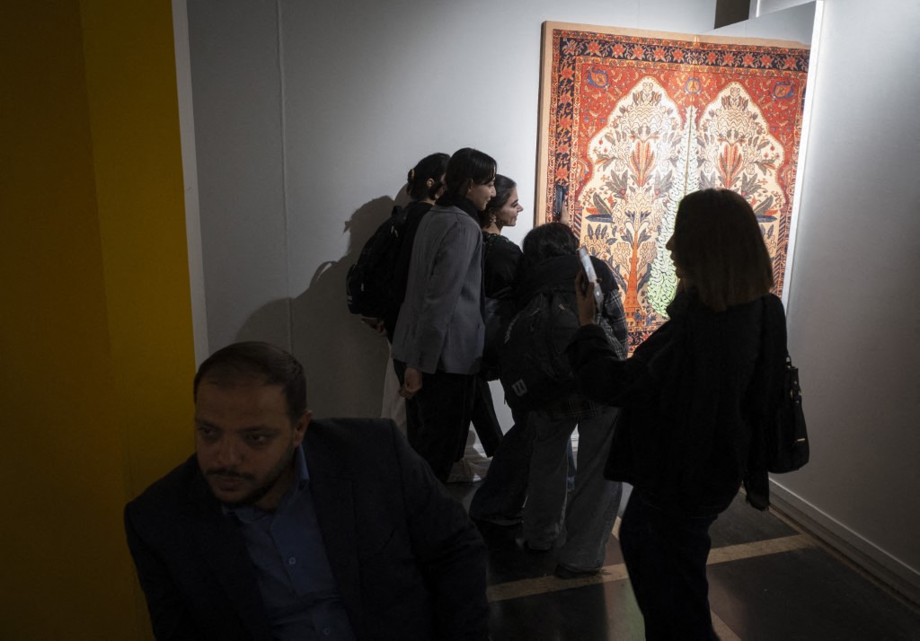 Young Iranian women visit an interactive art show during Tehran Design Week at the University of Tehran in Tehran, Iran, on November 11, 2025.