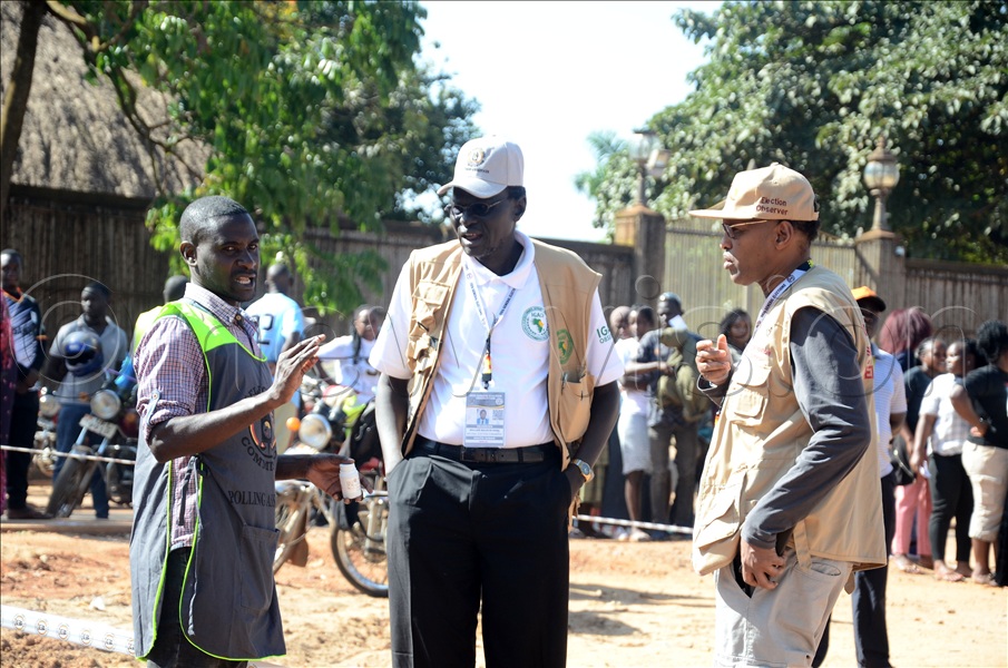 A polling agent interacting with election observers at Masiro compound polling centre during the presidential and parliamentary elections on January 15, 2026.