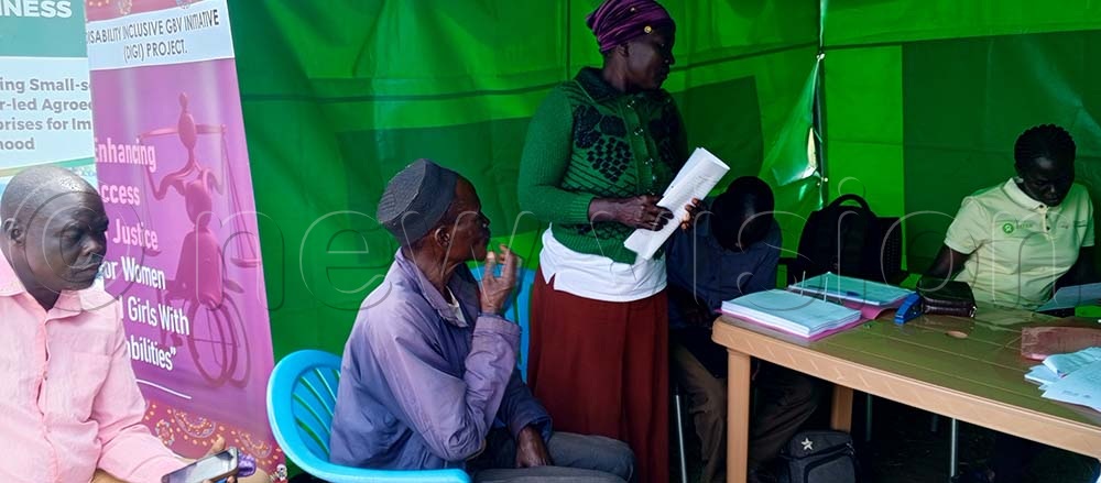 Locals in Logiri pay for the land registration forms at the land camp.