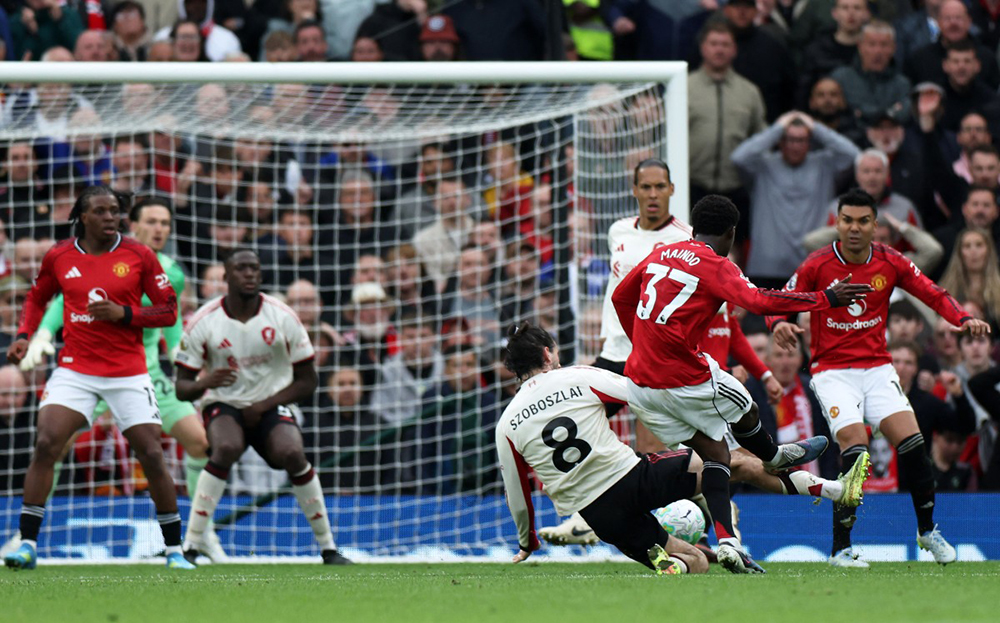 Manchester United's English midfielder #37 Kobbie Mainoo scores the team's third goal during the English Premier League football match between Manchester United and Liverpool at Old Trafford in Manchester, north west England, on May 3, 2026. 