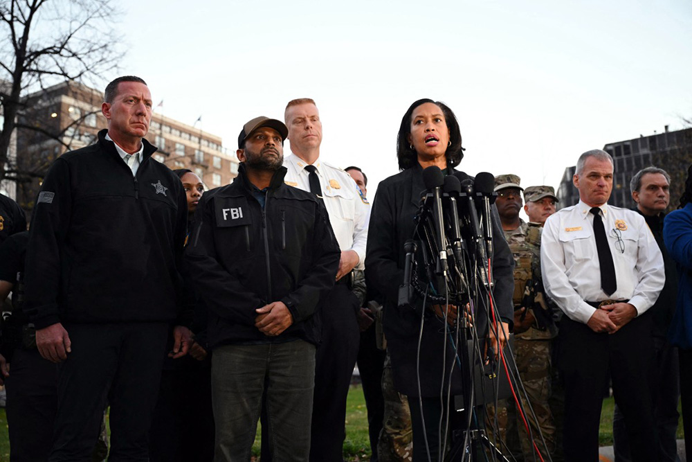 District of Columbia Mayor Muriel Bowser (2-R) accompanied by the FBI Director Kash Patel (2-L) speaks during a press conference after a shooting in downtown Washington, on November 26, 2025. (Photo by Drew ANGERER / AFP)
