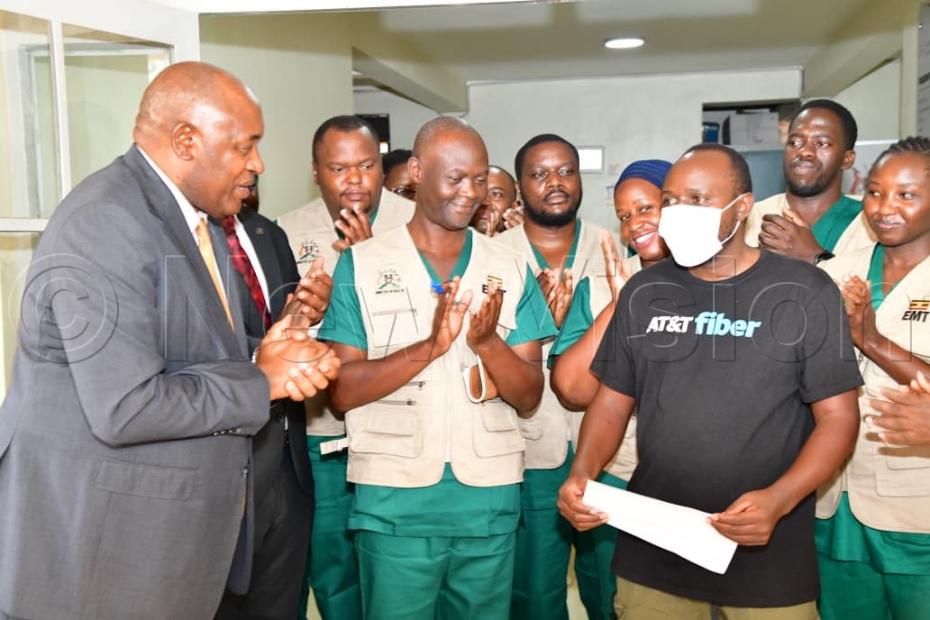 Health Minister Dr Chris Baryomunsi presents a certificate to the last Ebola survivor at the Mulago Isolation Unit on Thursday, July 16, 2026. (Credit: Mpalanyi Ssentongo)