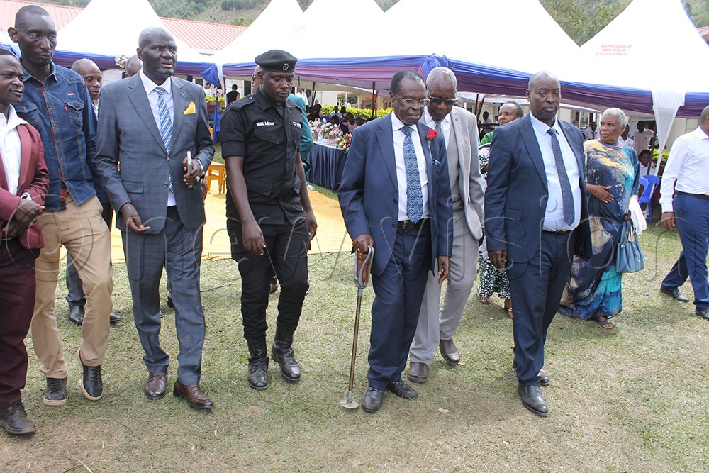Rwampara district chairman, Richard Owomugasho (5th from right), former Speaker of the Parliament of Uganda, Ambassador Francis Butagira (3rd from right), head teacher of Bugamba Secondary School, Robert Kihumuro Kijongoma (last on right), after attending the reunion of Bugamba SS in Rwampara district. (Photo by Abdulkarim Ssengendo)