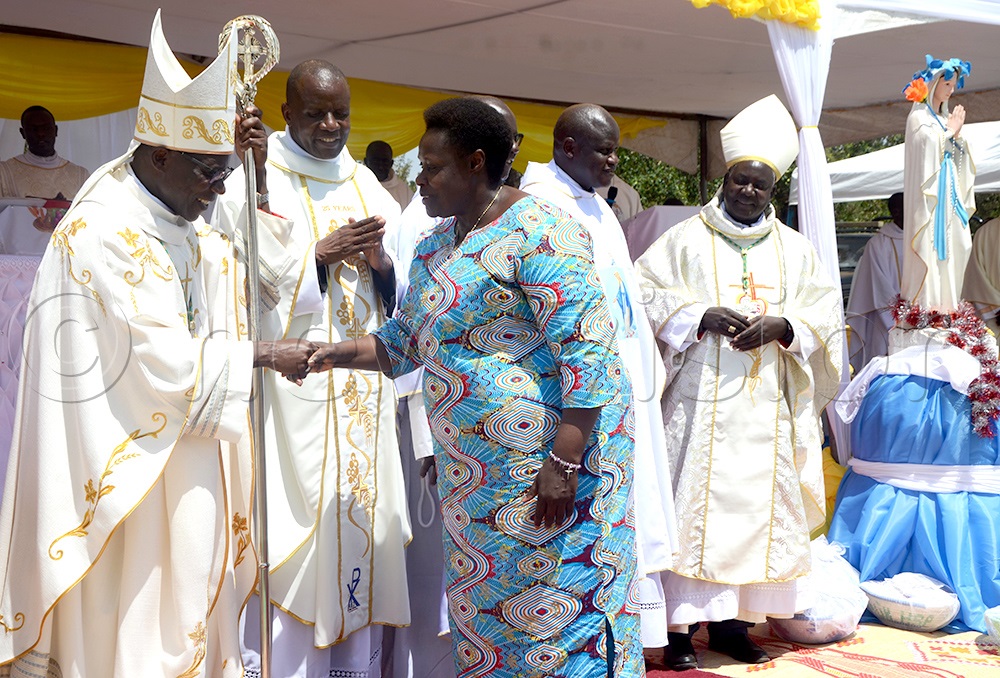  Vice President Jessica Alupo greeting Bishop Joseph Eciru Oliach and looking on the right is Bishop Dominic Eibu of Kotido Catholic Diocese during the silver jubilee celebrations in Wera, Amuria distict on Saturday. (Photo by Delux Emmy Alomu)