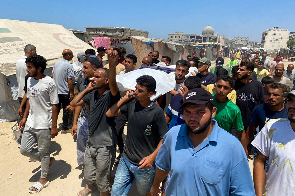 Mourners carry the body of one of five journalists killed in an Israeli strike on Nasser hospital in Khan Yunis in the southern Gaza Strip, during their funeral on August 25, 2025. (Photo by AFP)