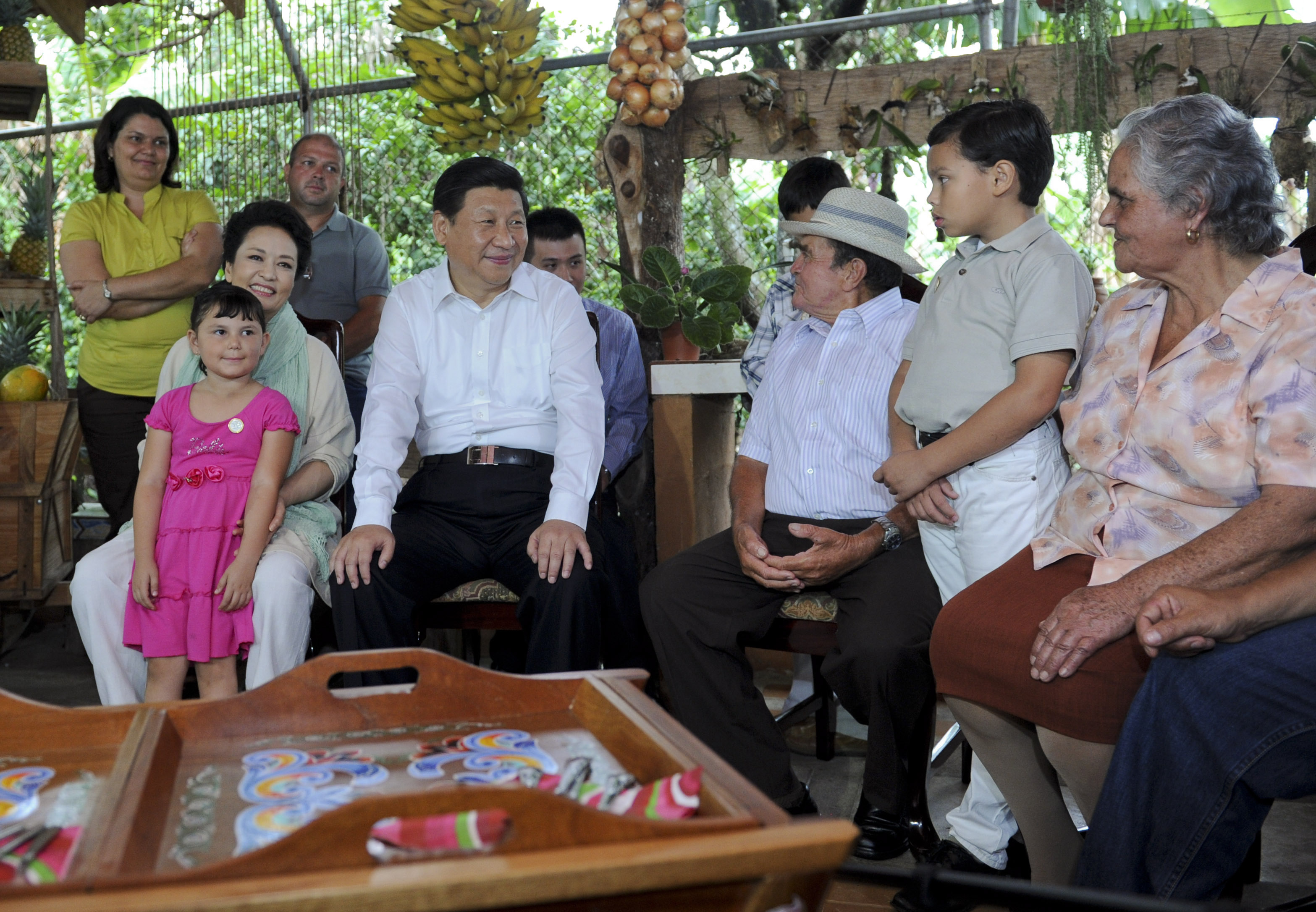 Chinese President Xi Jinping (2nd L, front) chats with members of a local farmer's family during a visit with his wife, Peng Liyuan, in Costa Rica, June 3, 2013.  (Xinhua)