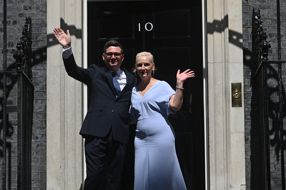 Britain's new Prime Minister Andy Burnham and his wife Marie-France van Heel pose on the steps of 10 Downing Street in central London on July 20, 2026, after being asked by the king to form the next government.