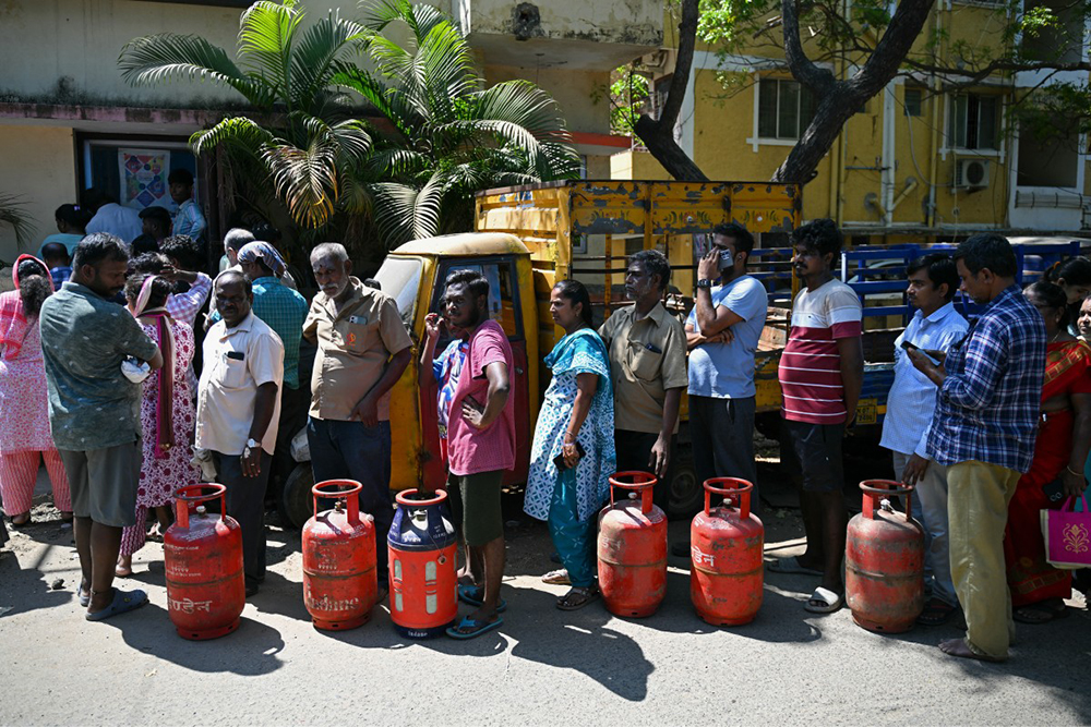 People queue to buy liquefied petroleum gas (LPG) cylinders for domestic use, at a gas agency office in Chennai on March 11, 2026. India ordered tighter controls over natural and cooking gas on March 10 following import disruptions caused by the Middle East war, with restaurants warning it could spark widespread closures. 