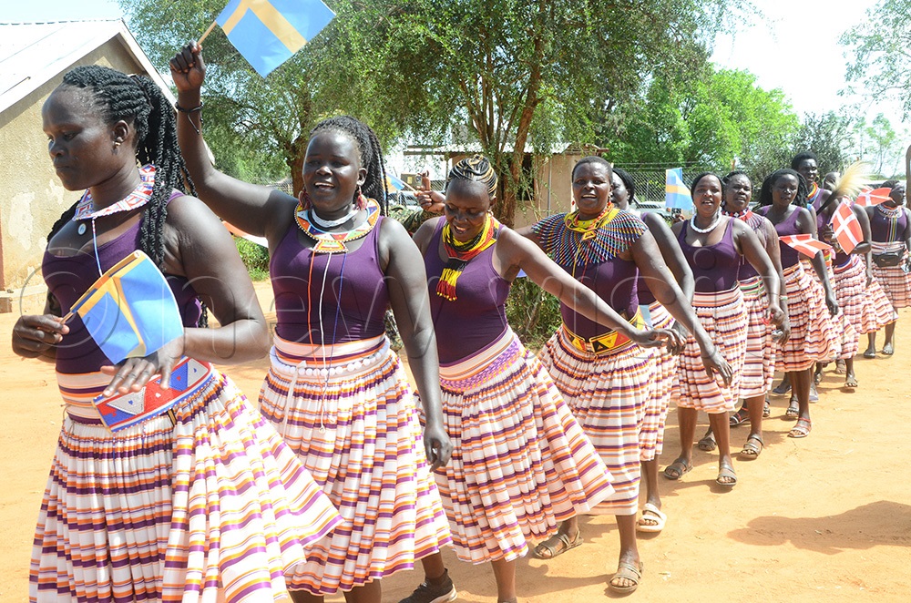 A Karamoja cultural women group entertains ambassadors at Lokodiokodioi Primary School in Napak district. (Photo by Olandason Wanyama)