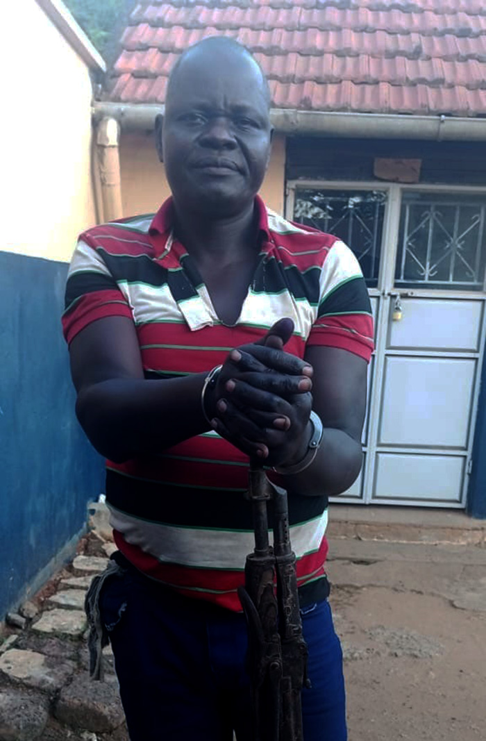 The suspected killer, David Emenyu alias Olipong holding the gun he used to kill Patricia Kokunda. (Credit: Police)