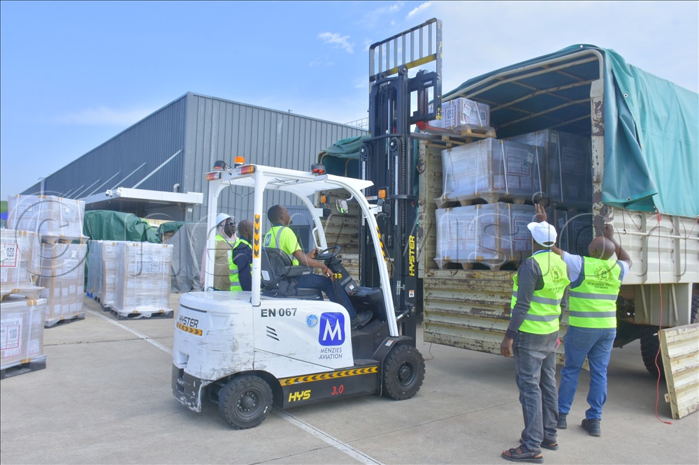 Loading the election material onto the EC trucks at Entebbe airport on Sunday.