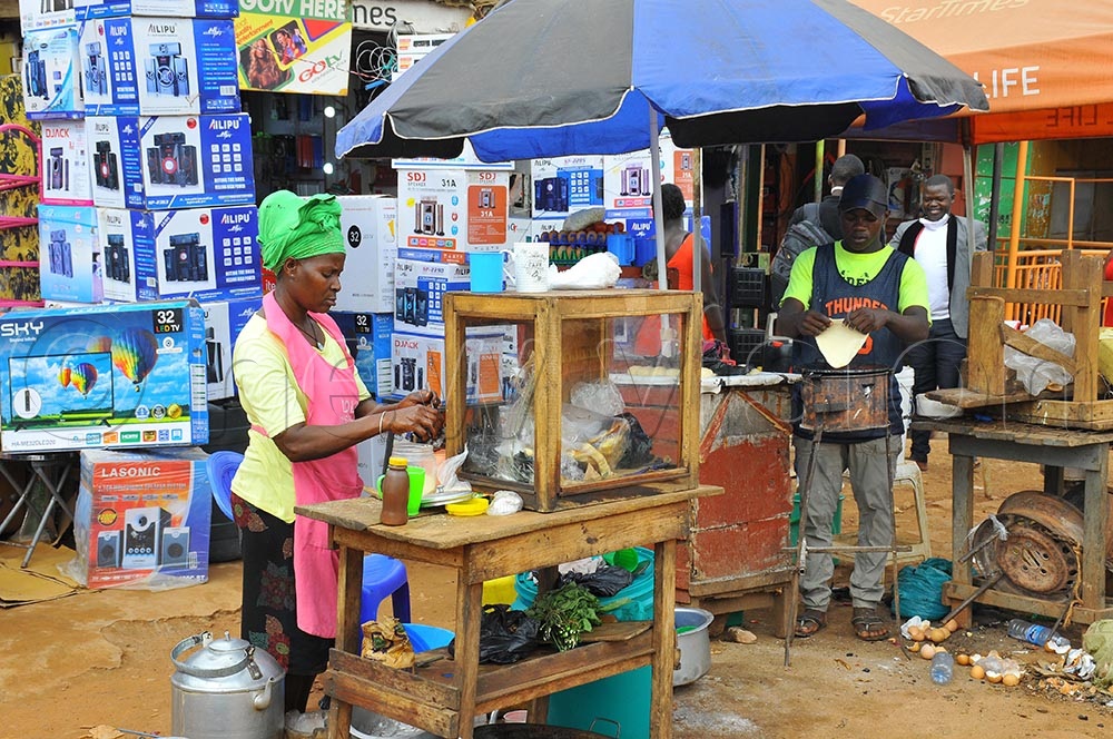 A lady in the food sector preparing tea, which is one of the businesses that need to be formerlised along Jinja Road in Wakiso district. (Credit: Wilfred Sanya)