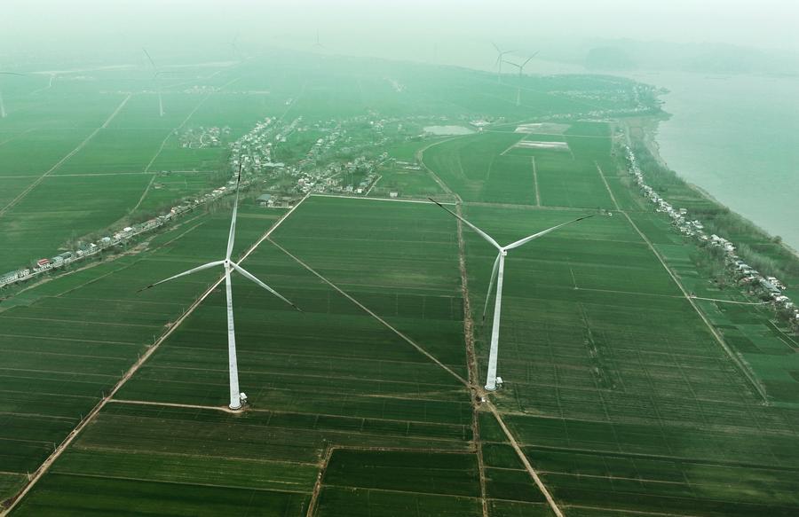 This drone photo shows the wind turbines on Mianchuan Island of Jiujiang City, east China's Jiangxi Province, Jan. 29, 2026. The island's zero-carbon facilities include energy storage systems, photovoltaic carports, and charging stations. (Xinhua/Wan Xiang)