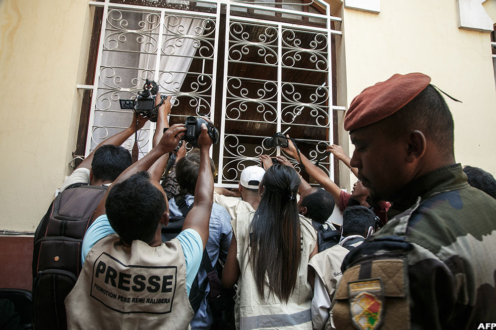 Journalists try to film the swearing-in ceremony of Army colonel Michael Randrianirina as President of Madagascar in Antananarivo on October 17, 2025. (AFP)
