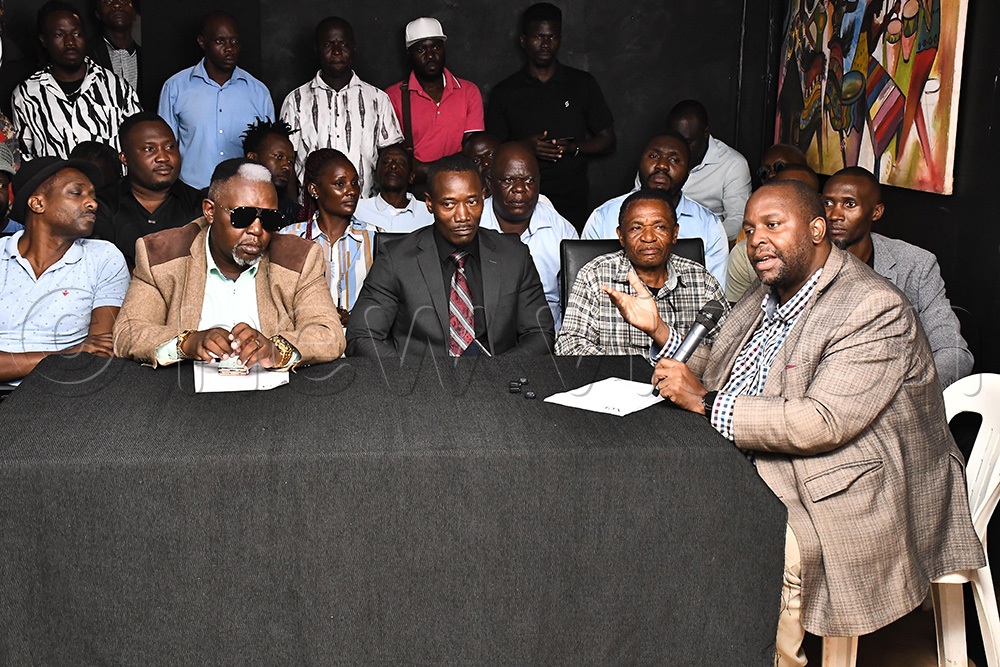 Jeff Ekongot (holding a microphone) of Uganda Musicians Association addressing members of the press at National Theatre. (Photo by Ignatius Kamya)