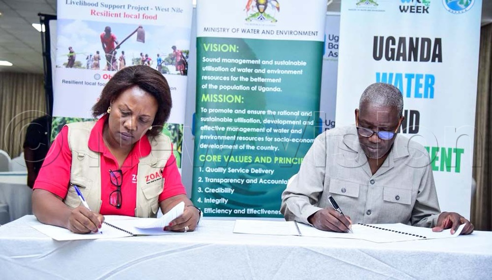 Pauline Onen, from ZOA Uganda and Dr Alfred Okidi, water ministry PS sign memorandum of understanding during the breakfast meeting at Skyz hotel in Naguru on Friday, March 6, 2026. (Photo by Juliet Kasirye)