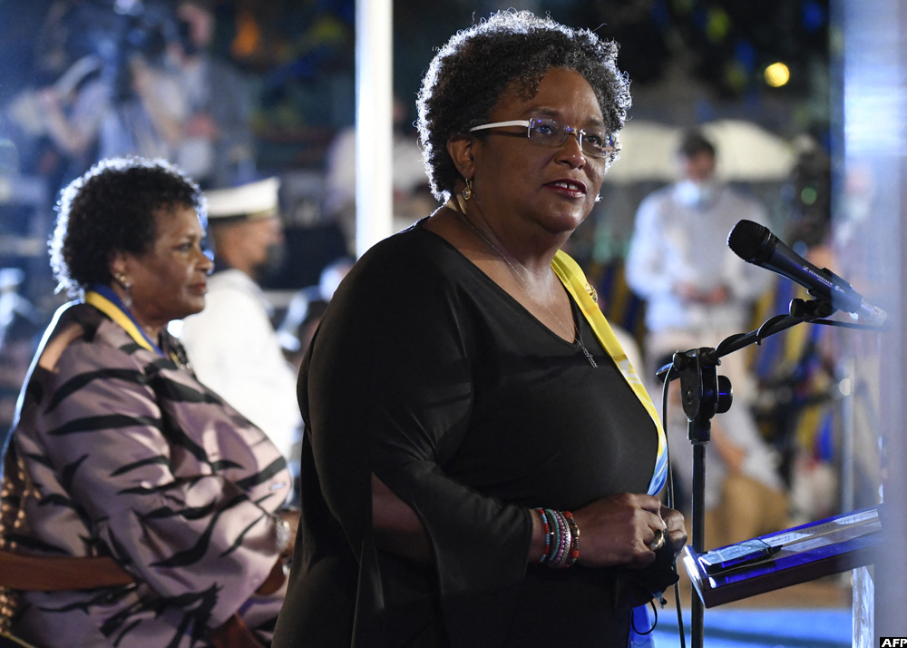 Prime Minister Mia Amor Mottley (R) addresses the nation as President of Barbados Dame Sandra Mason (L) listens during the ceremony