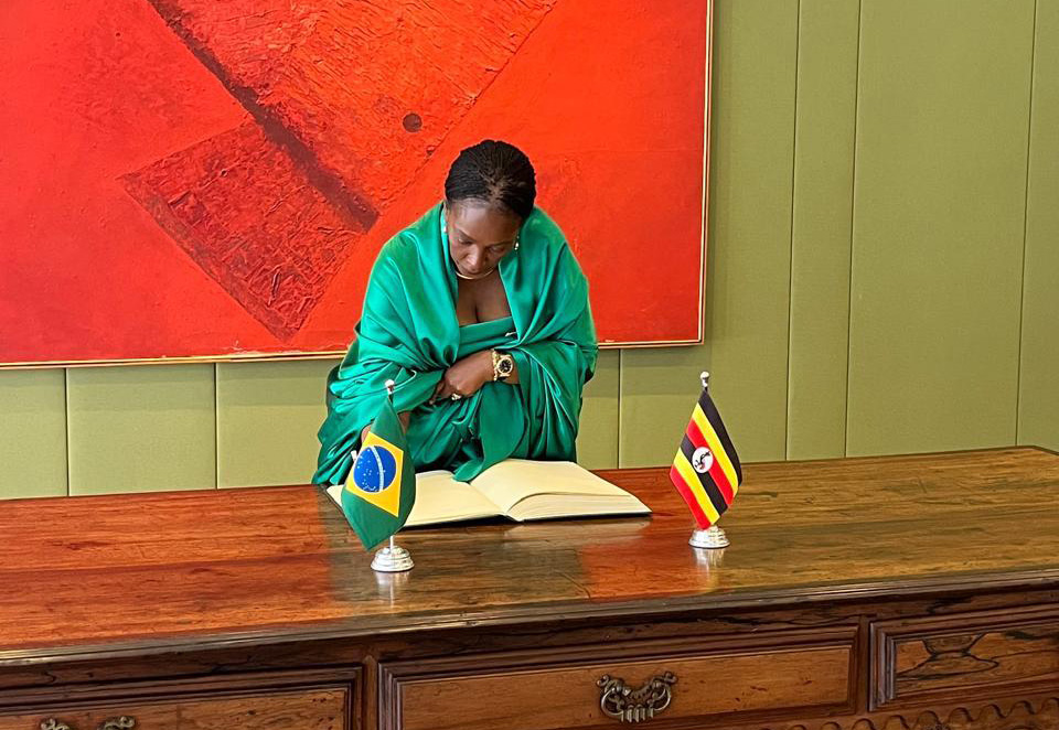 Ambassador Robie Kakonge signing formal documents after handing over their Letters of Credence to President Luiz Inácio Lula da Silva of Brazil. (Courtesy photo)