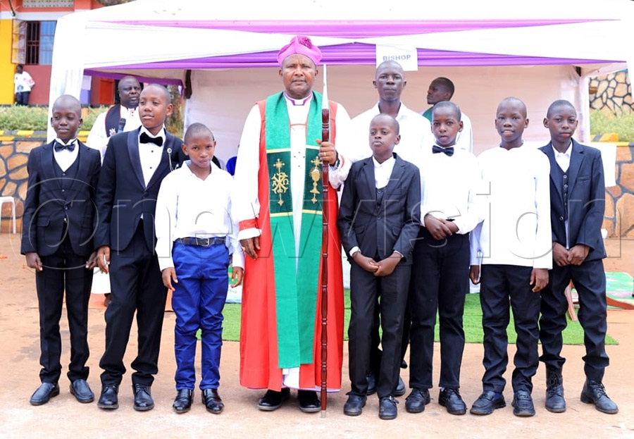 Bishop Enos Kitto Kagodo poses with some of the boys who were confirmed