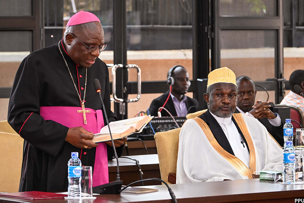 Archbishop of Kampala Archdiocease Paul Ssemogerere leads prayers during Heroes day celebrations at Nakasero on Tuesday as Deputy Mufuti  of Uganda Sheikh Muhammad Waiswa looks on. (PPU Photo)