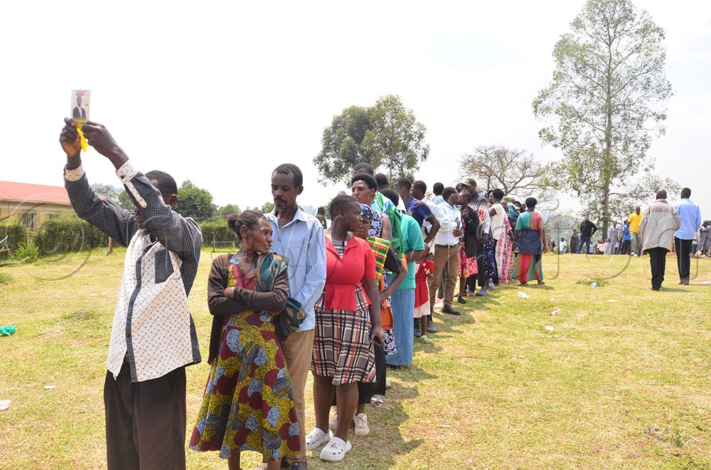 Supporters of Mathius Rwabugumi lining up behind a supporter holding his poaster in Nyakiju where he polled 39 votes against Bob Rugonde's 159 votes. (Photo by Caleb Bahikaho)