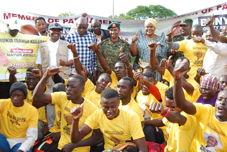 Third Deputy Prime Minister Rukia Isanga Nakadama (centre) with Lt Col Mercy Tukahirwa pose for a group photo with some of the youths who defected from NUP to NRM at the function. (Photo by Doreen Musingo)