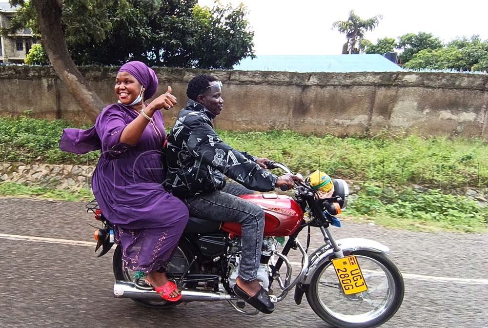 A boda boda rider transporting Amina Sijali Abiriga who was nominated on independent ticket for Anyafio Golf cell in Arua City. (Credit: Robert Ariaka)