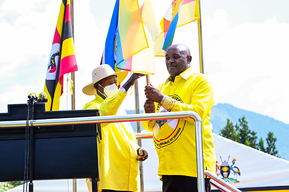President Museveni hands over the party flag to Dr Chris Baryomunsi during a campaign rally at Rwere play grounds in Kinkinzi East in Kanungu district on Wednesday, Nov. 26, 2025. (PPU)