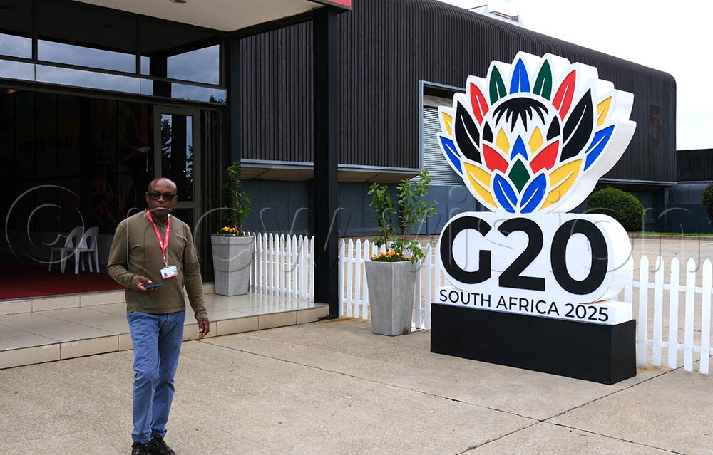 A man walks past a G20 signage at Johannesburg Expo Centre, on November 21, 2025. (Credit: Hajarah Nalwadda