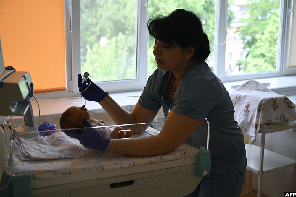 A nurse holds a newborn baby at a maternity department of the Mechnikov Hospital in the city of Dnipro on June 8, 2026
