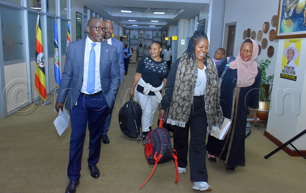 Topher Matsiko (left) the Head of Liaison and Partnerships under the State House Diaspora Unit leading the returnees Fiona Namuddu and Rebecca Nakasaga upon their return from India. (Photo by Julius Luwemba)