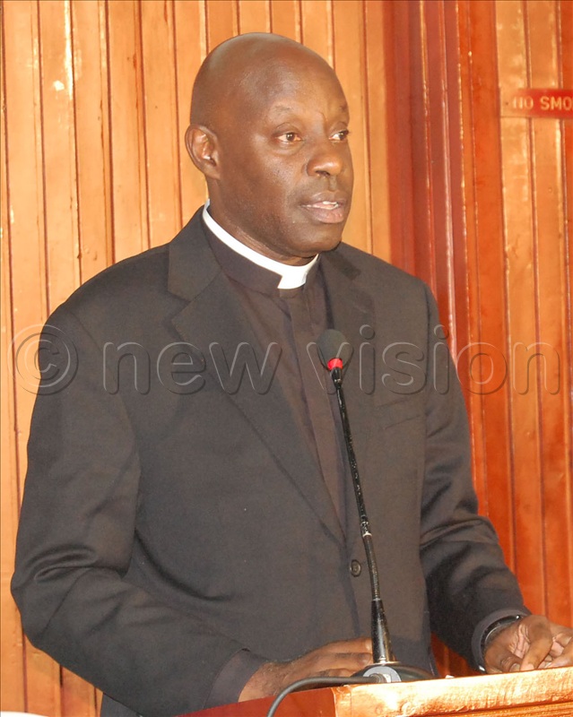 The Vicar General of Kampala archdiocese, Msgr. Rogers Kabuye Mukasa delivers the message of archbishop Paul Ssemogerere.