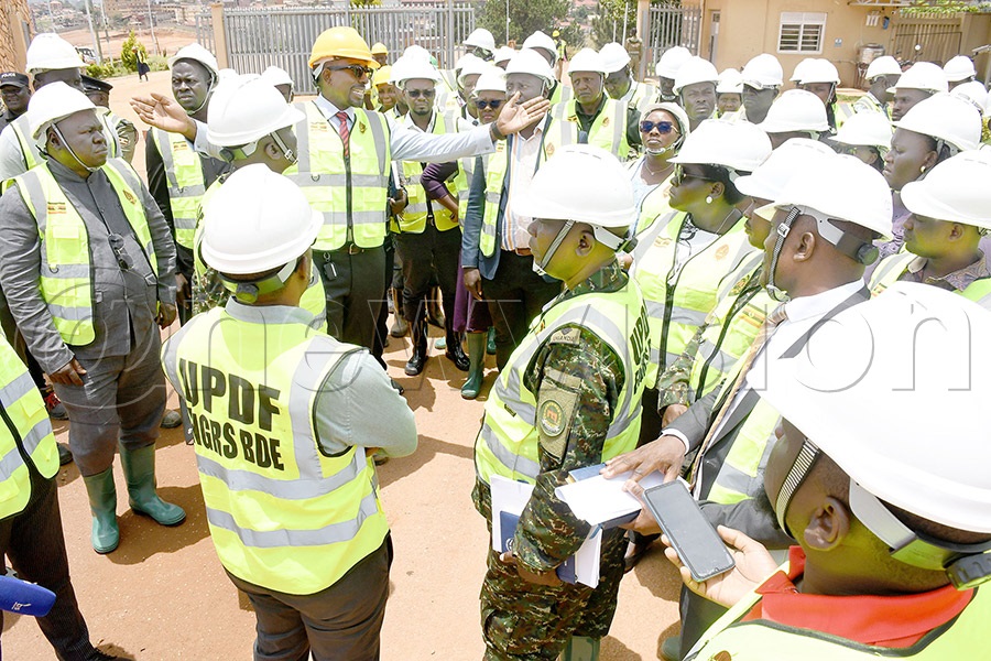 NCS Chairman Ambrose Tashobya (with yellow helment) briefs MPs on ongoing works at the Mandela National Stadium Namboole, October 5, 2026. Photo by Michael Nsubuga
