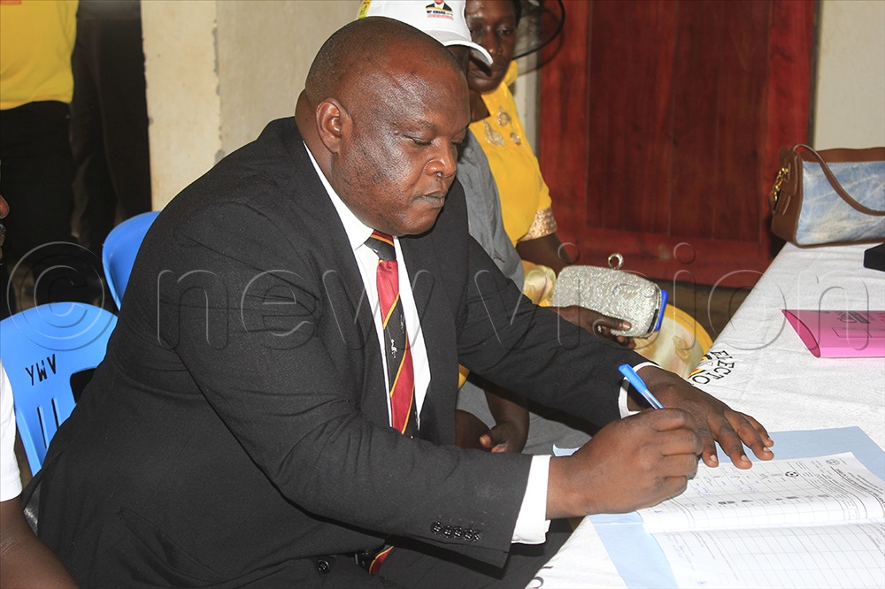 Tony Ayo signs E.C documents before being nominated on Monday.