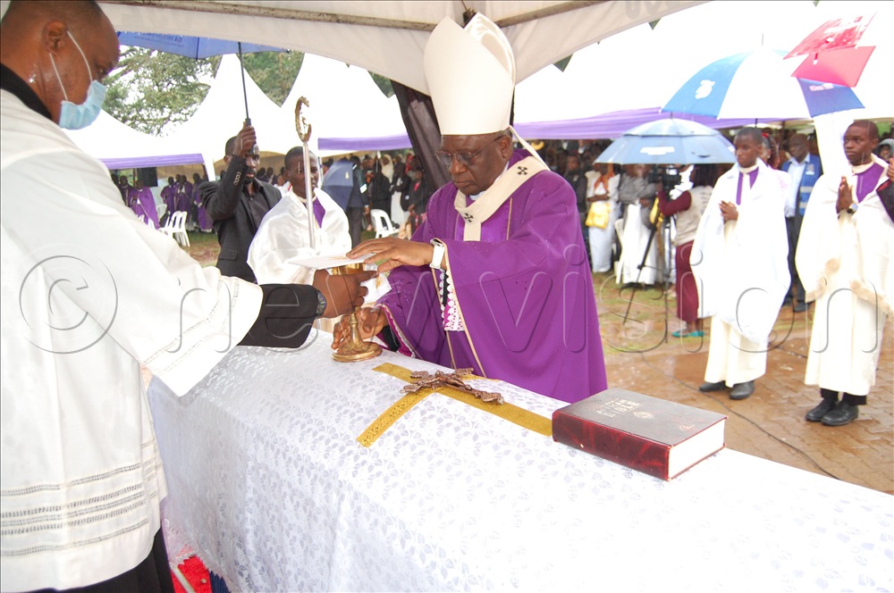 Archbishop Paul Ssemogerere (wearing a mitre) places a chalice on the casket containing the remains of Fr. Simon Peter Kawooya during the requiem mass at Kisubi Minor Seminary on Wednesday, August 5, 2026. 
