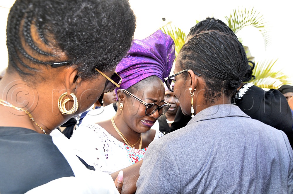 The deputy registrar of the International Crimes Division of the High Court in Uganda, Juliet Harty Haitanga (C) being comforted by relatives and friends after a funeral service of her daughter, late Thelma Abongo Haitanga, at All Saint Cathedral, Nakasero in Kampala on August 5 2025. (All photos by Ronnie Kijjambu)